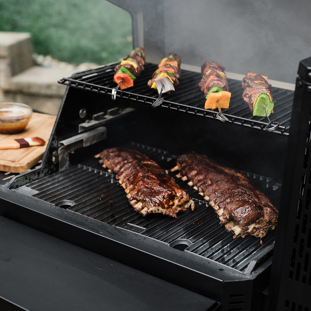 The FoldAway warming + smoking racks provide extra cooking space, while the stainless steel front shelf provides extra preparation space.